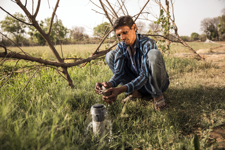 Sita’s husband, Bherulal, checks the cap on an irrigation pipe that runs alongside their fields. Thanks to their increased income from JIVA-taught practices, Bherulal and Sita continue to invest in their farm. In 2015, they invested 40,000 rupees to deepen their well. They also recently invested 25,000 rupees to level their farmland making it easier to irrigate.